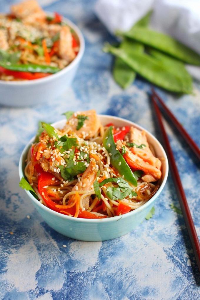 bowl of salmon soba noodles with vegetables beside chopsticks