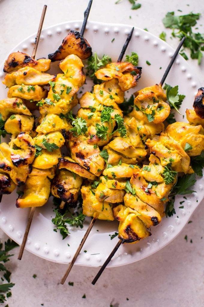 several grilled honey mustard chicken skewers on a plate