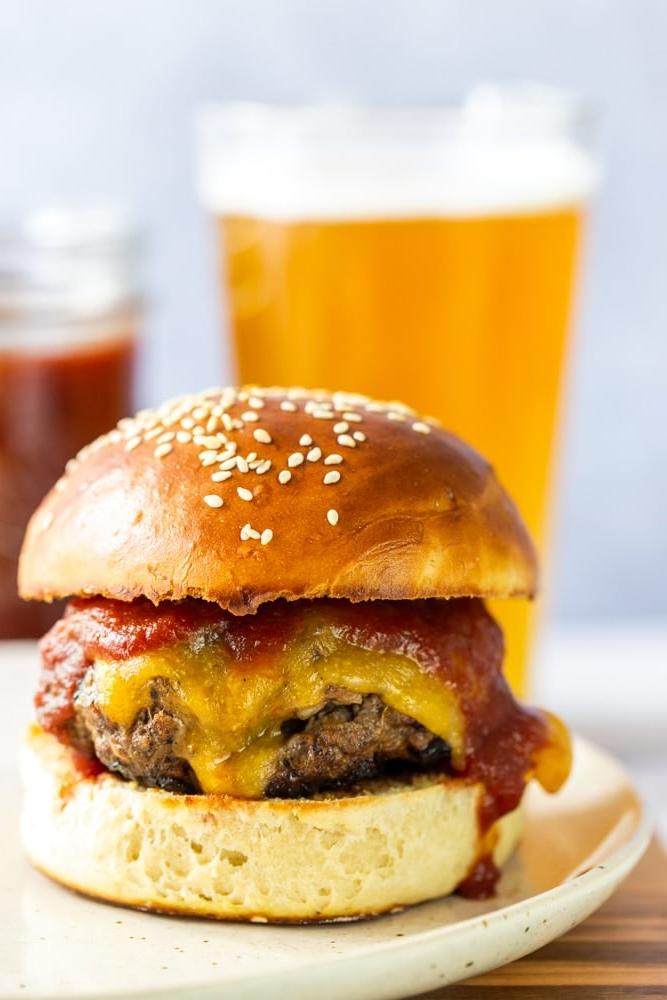 BBQ cheeseburgers with a glass of beer