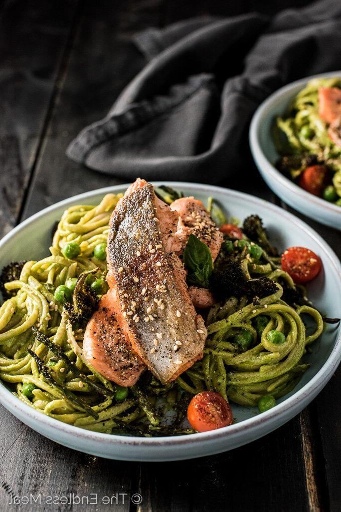green goddess pasta bowls topped with salmon and baby tomatoes