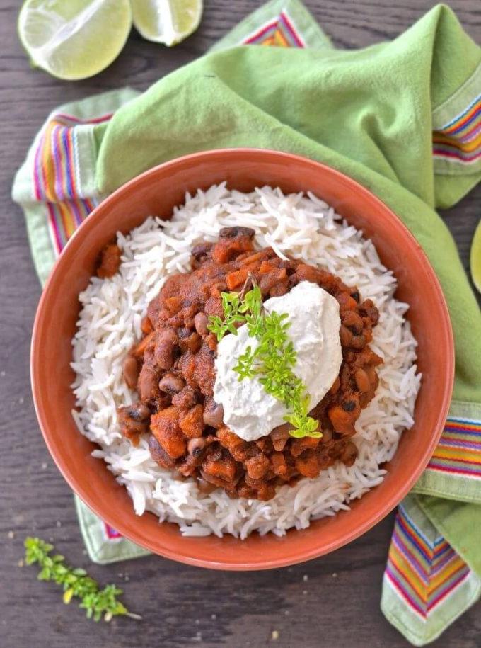 three bean sweet potato chili on rice in a bowl