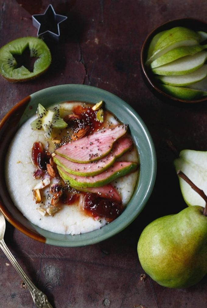 vegan millet porridge in a bowl with apple slices and a pear