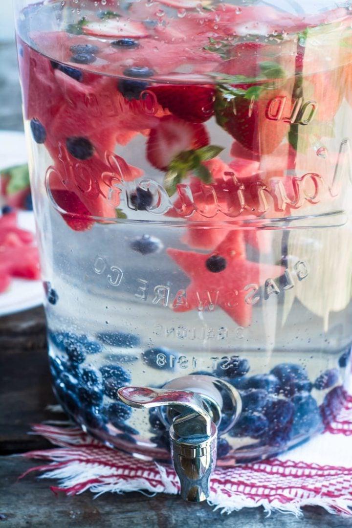pitcher with patriotic cut out watermelon (star shapes) and blueberries