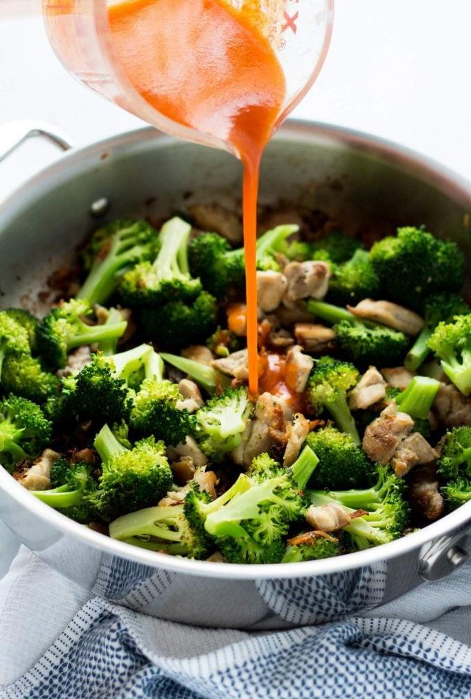 metal skillet with buffalo chicken and broccoli