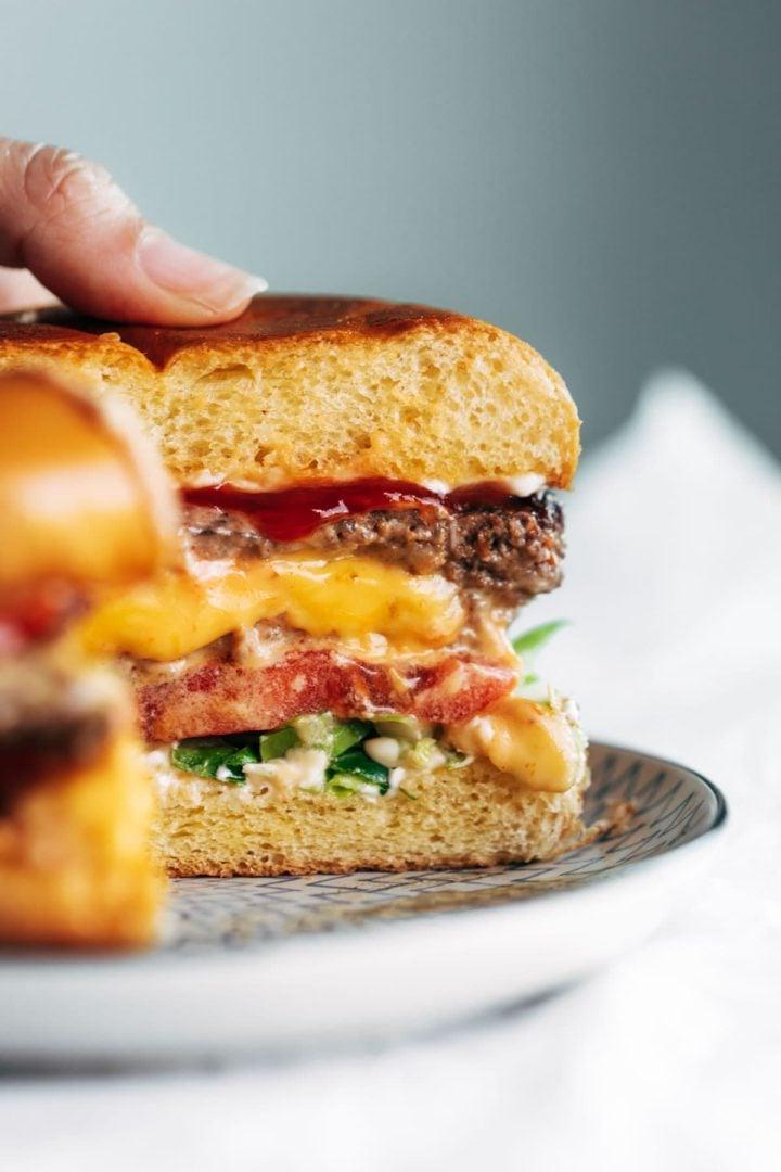 Juicy Lucy burgers (cut in half and cheese coming out)