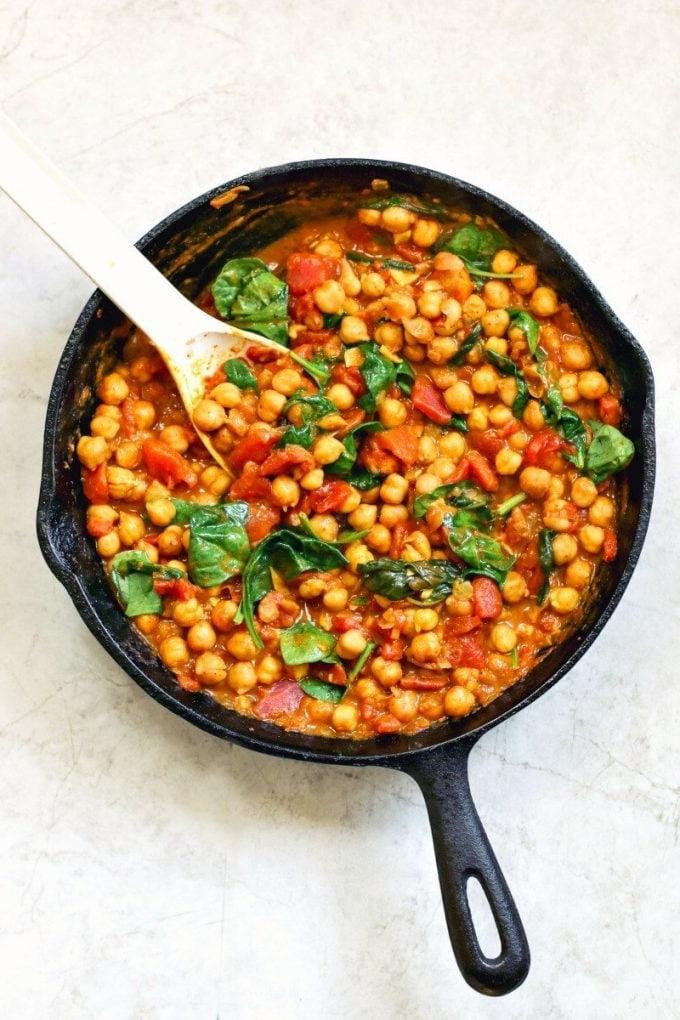cast iron skillet with chickpea and spinach curry