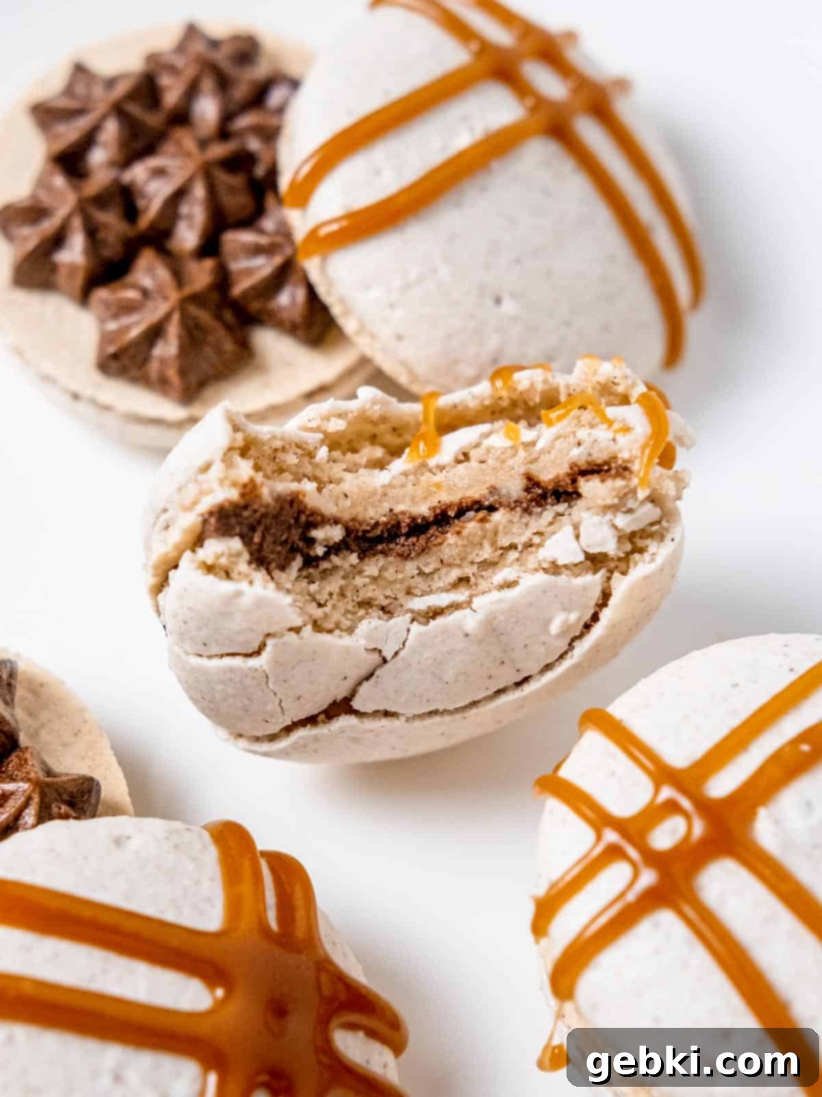 a close up of a dirty chai macaron with a bite taken out of it