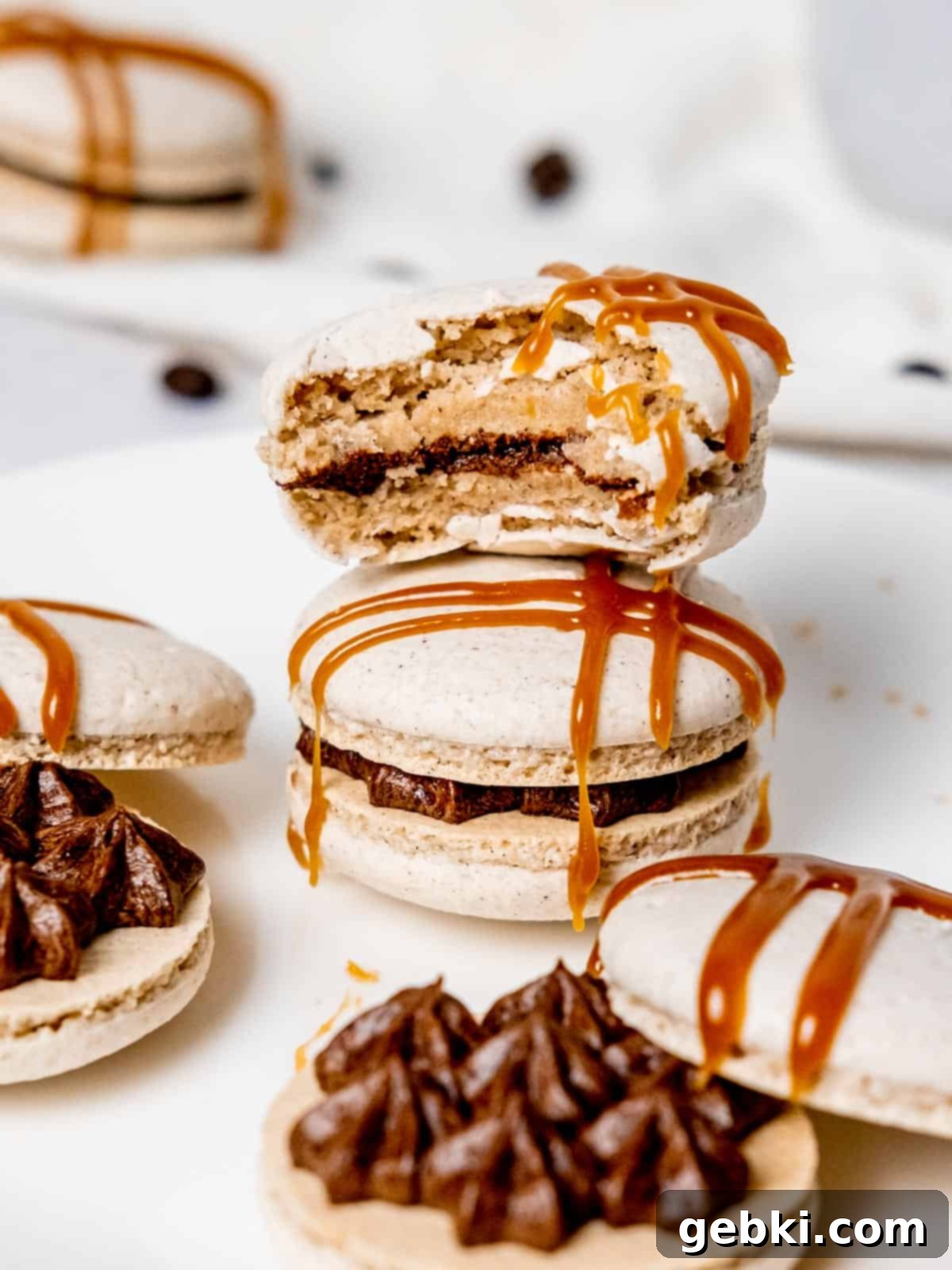 a stack of dirty chai macarons with a bite taken out of the top one