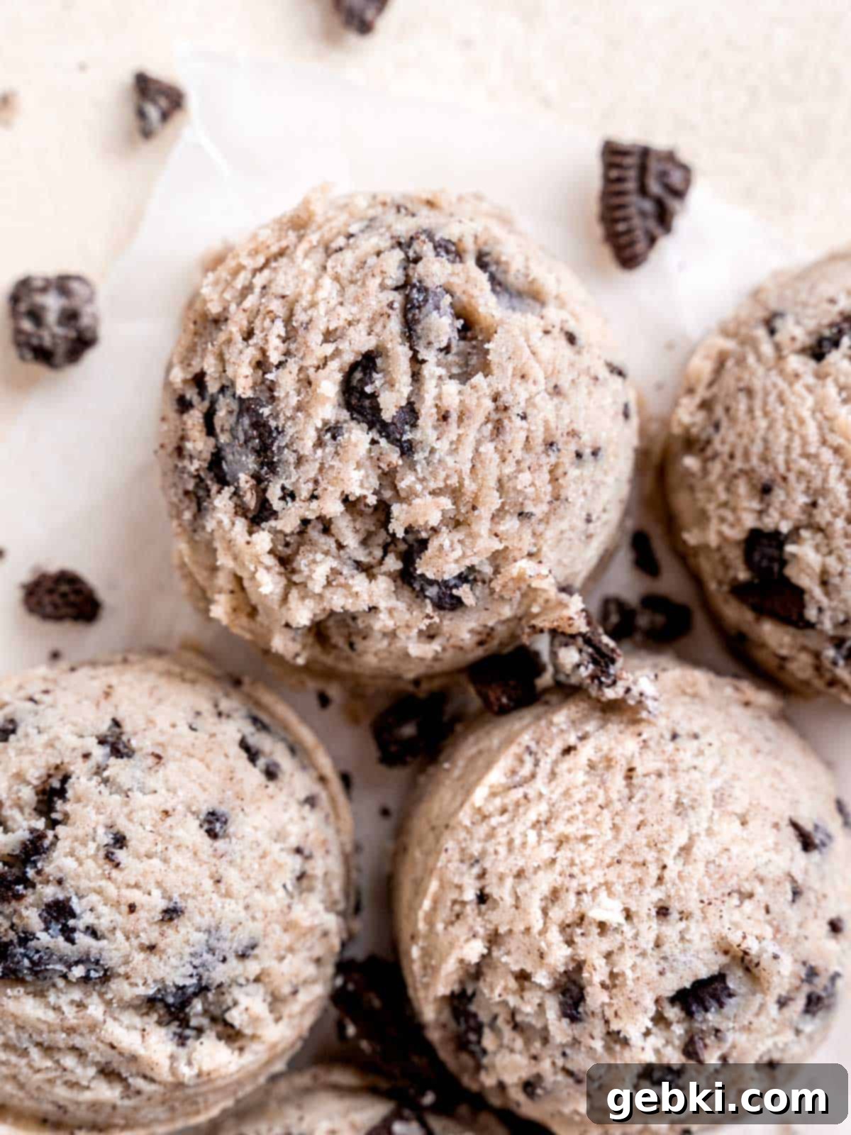 No-Bake Cookies and Cream Cookie Dough 2 Scoops of cookies and cream cookie dough surrounded by chopped Oreos.