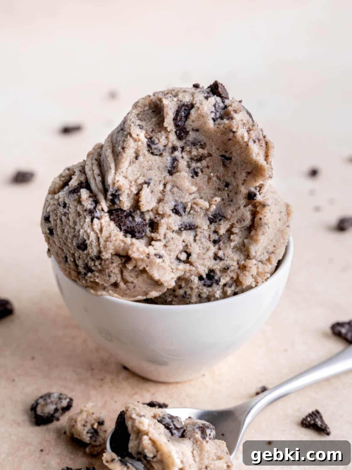 No-Bake Cookies and Cream Cookie Dough 5 Scoops of edible Oreo cookie dough in a small bowl with a spoonful taken out.