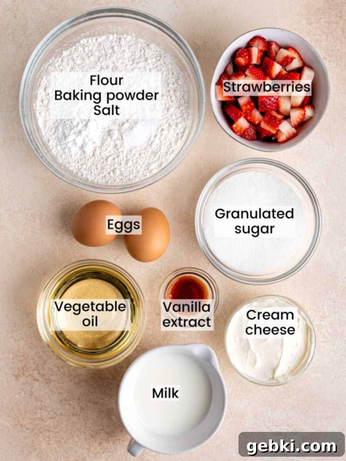 Luscious Strawberry Cream Cheese Muffins 3 A flat lay of ingredients needed to make strawberry cream cheese muffins, including flour, sugar, strawberries, and cream cheese.