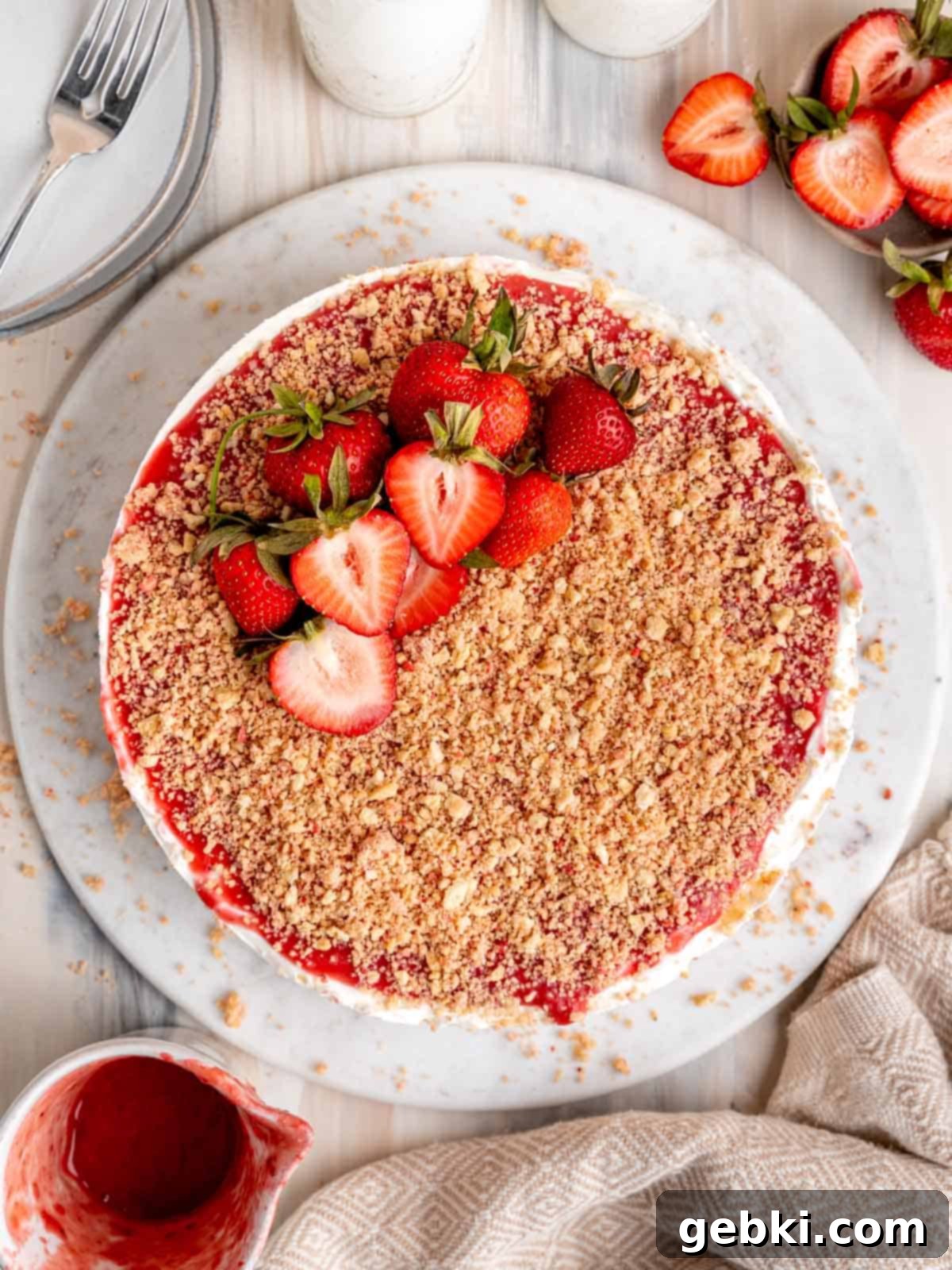 No Bake Strawberry Crunch Cheesecake 2 Top view of a no bake strawberry crunch cheesecake, showcasing its creamy filling and crunchy topping.
