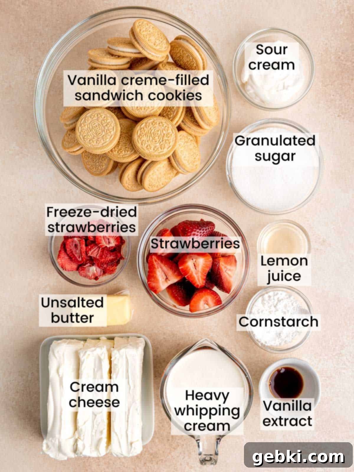 No Bake Strawberry Crunch Cheesecake 3 Assortment of fresh and dry ingredients laid out to make a no bake strawberry crunch cheesecake, including Golden Oreos, fresh strawberries, cream cheese, and heavy cream.
