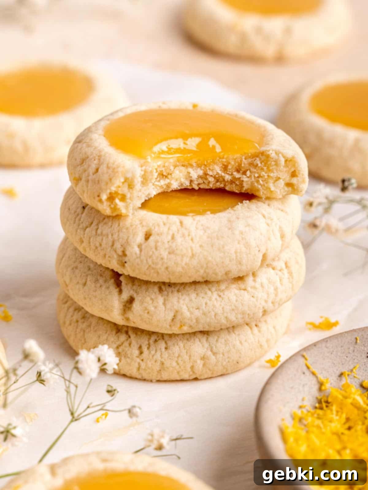 Simple Lemon Curd Thumbprint Cookies 2 A stack of lemon curd thumbprint cookies.