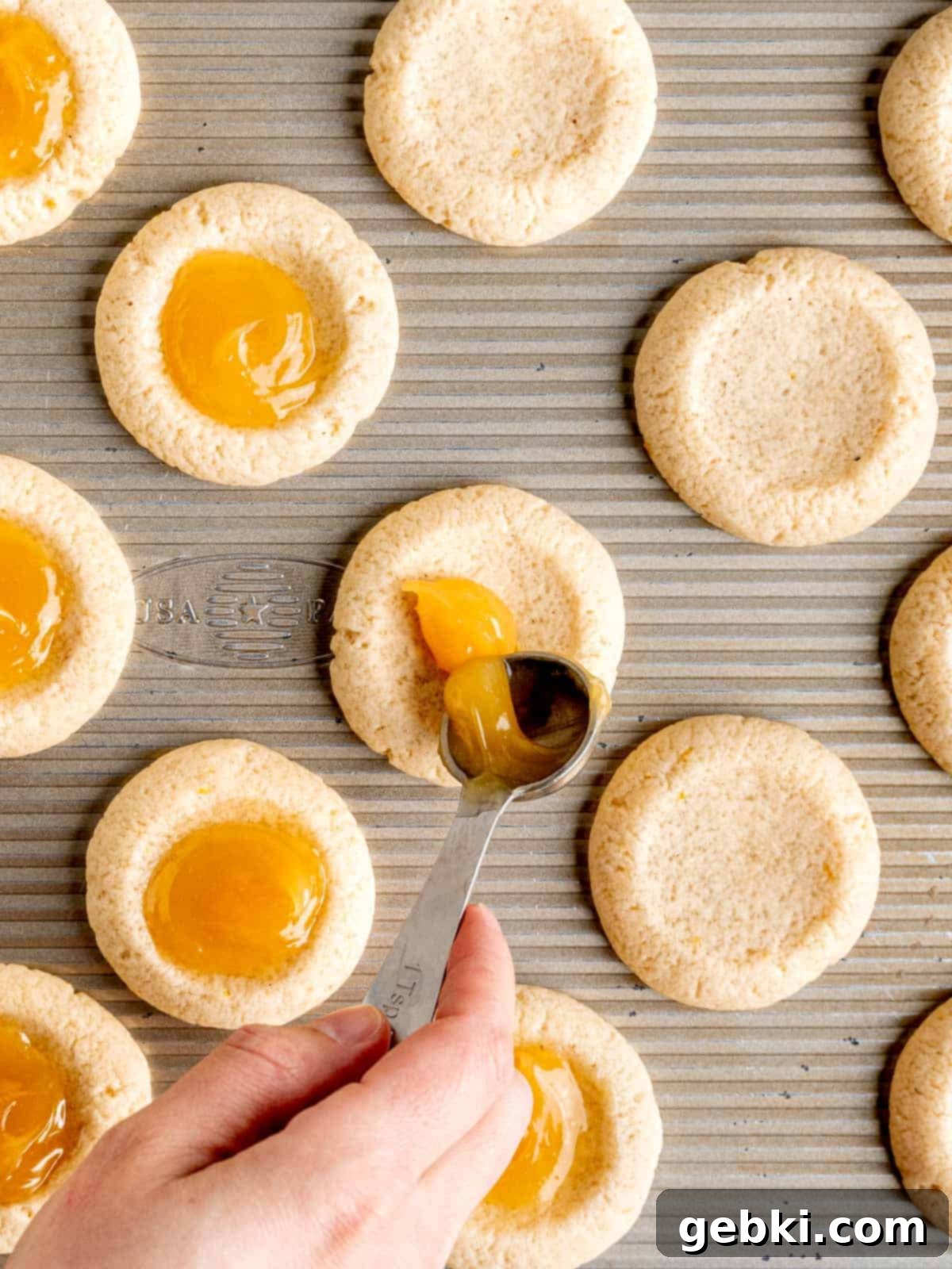 Simple Lemon Curd Thumbprint Cookies 8 Filling the centers of thumbprint cookies with lemon curd.