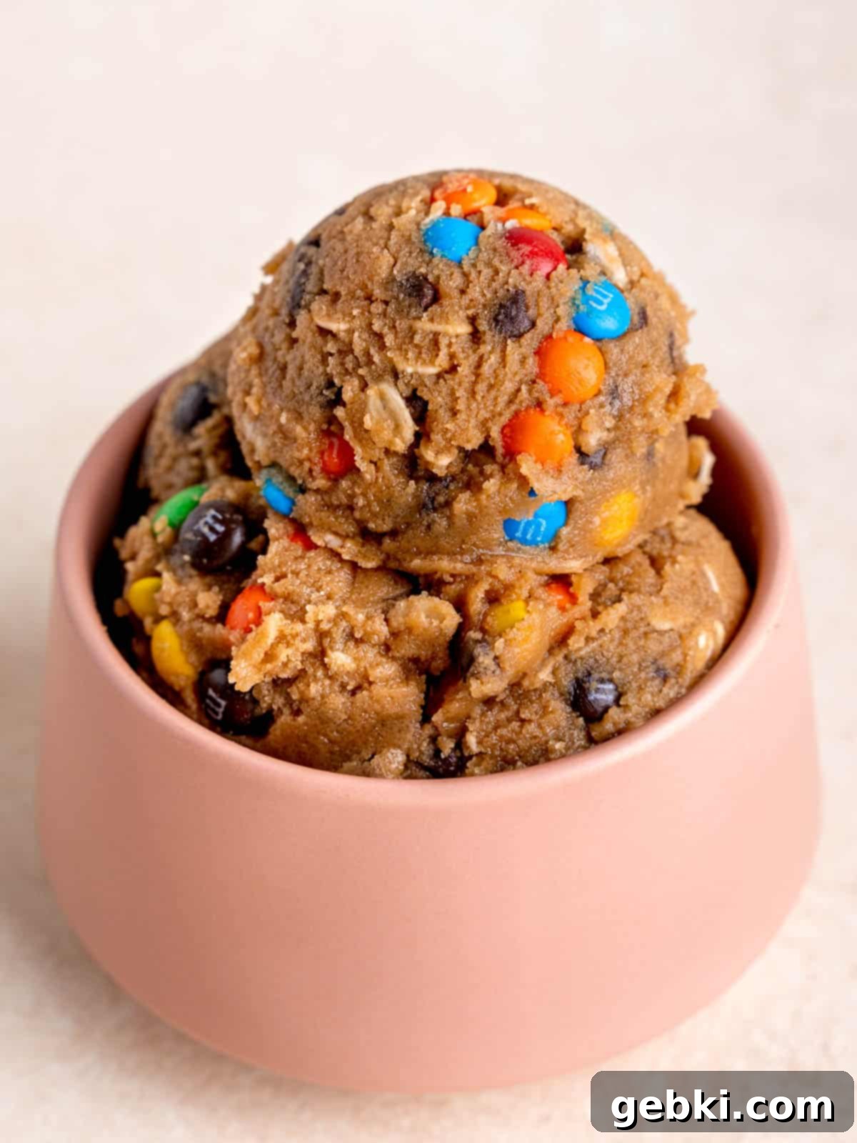 Doughlicious Monster Treat 5 Scoops of edible monster cookie dough in a cheerful pink bowl, ready to be enjoyed.