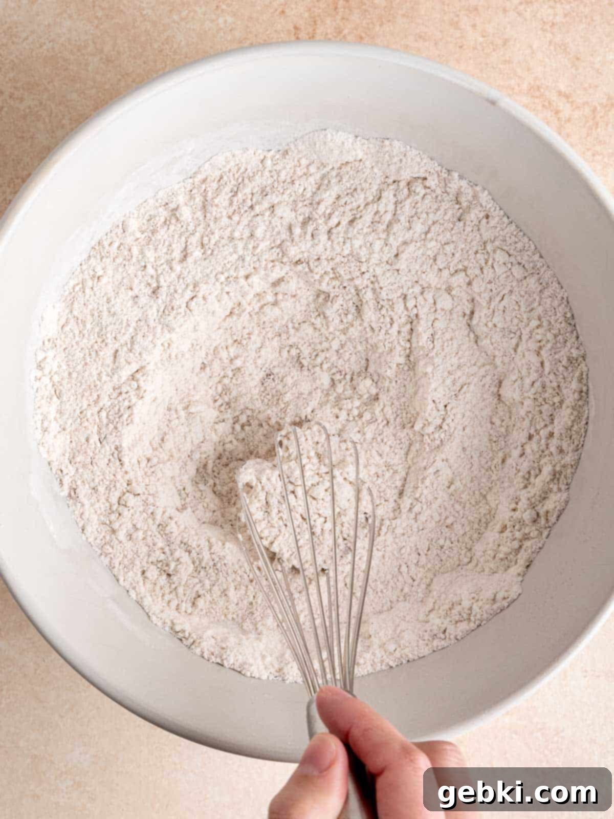 Whisking flour, sugar, baking powder and cinnamon in a large bowl.