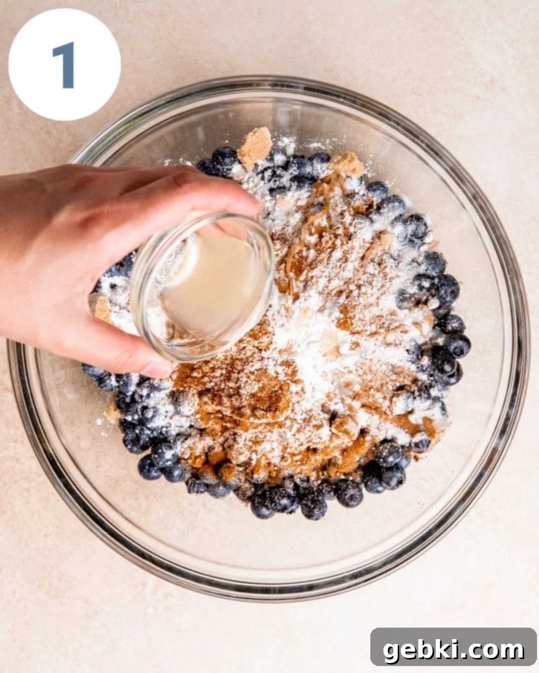 Aromatic Blueberry Delight 4 Step-by-step image showing blueberries being mixed with sugars and spices in a bowl.