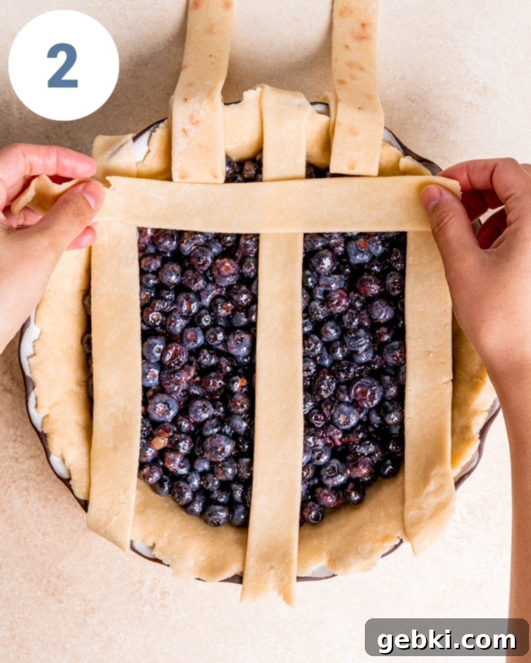 Aromatic Blueberry Delight 7 Folding back alternating strips to weave a new horizontal strip for the lattice pie crust.