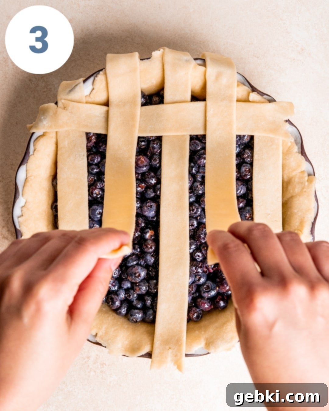 Aromatic Blueberry Delight 8 The lattice pattern of the pie crust taking shape, with strips woven over and under.
