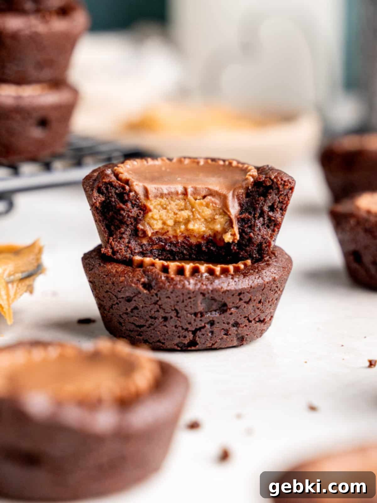Peanut Butter Cup Brownie Bites 2 A mini peanut butter cup brownie with a bite taken out of it sitting on top of a whole one.