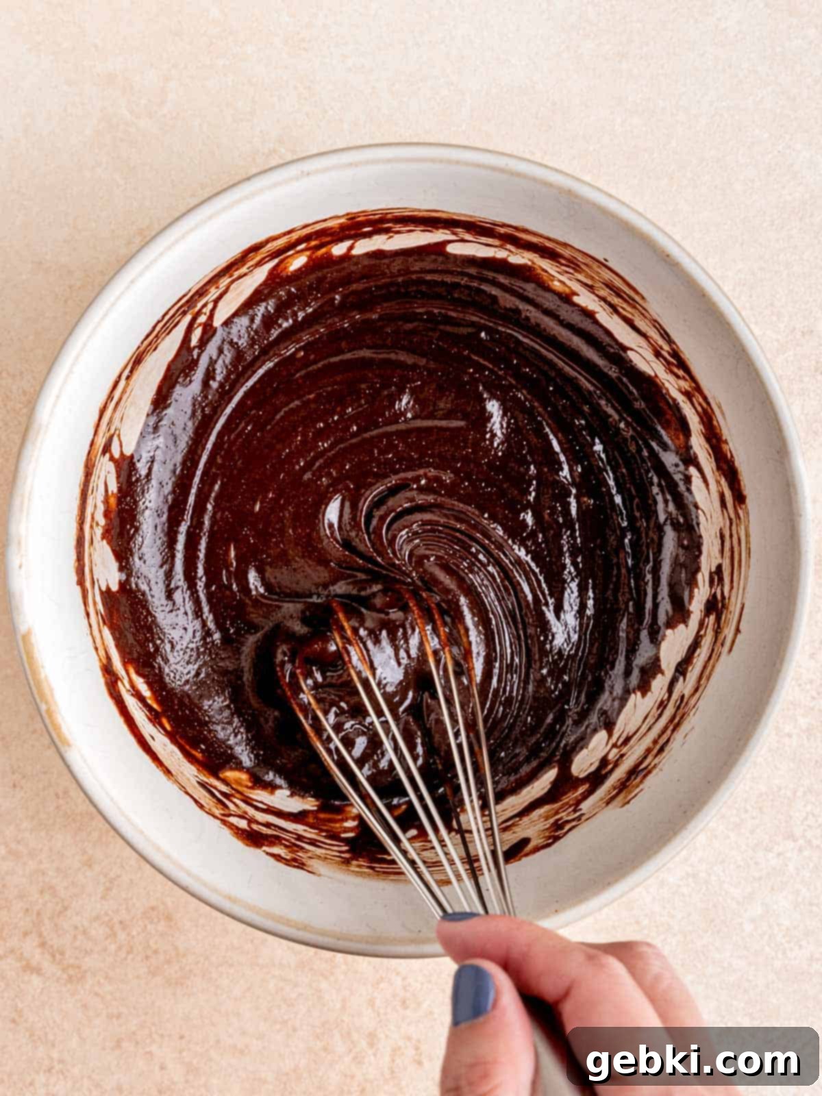 Peanut Butter Cup Brownie Bites 4 Whisking chocolate batter in a bowl.