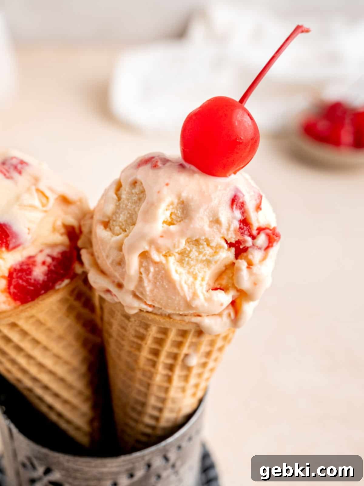 Amaretto Cherry Bliss 2 A sugar cone with a scoop of homemade cherry amaretto ice cream.