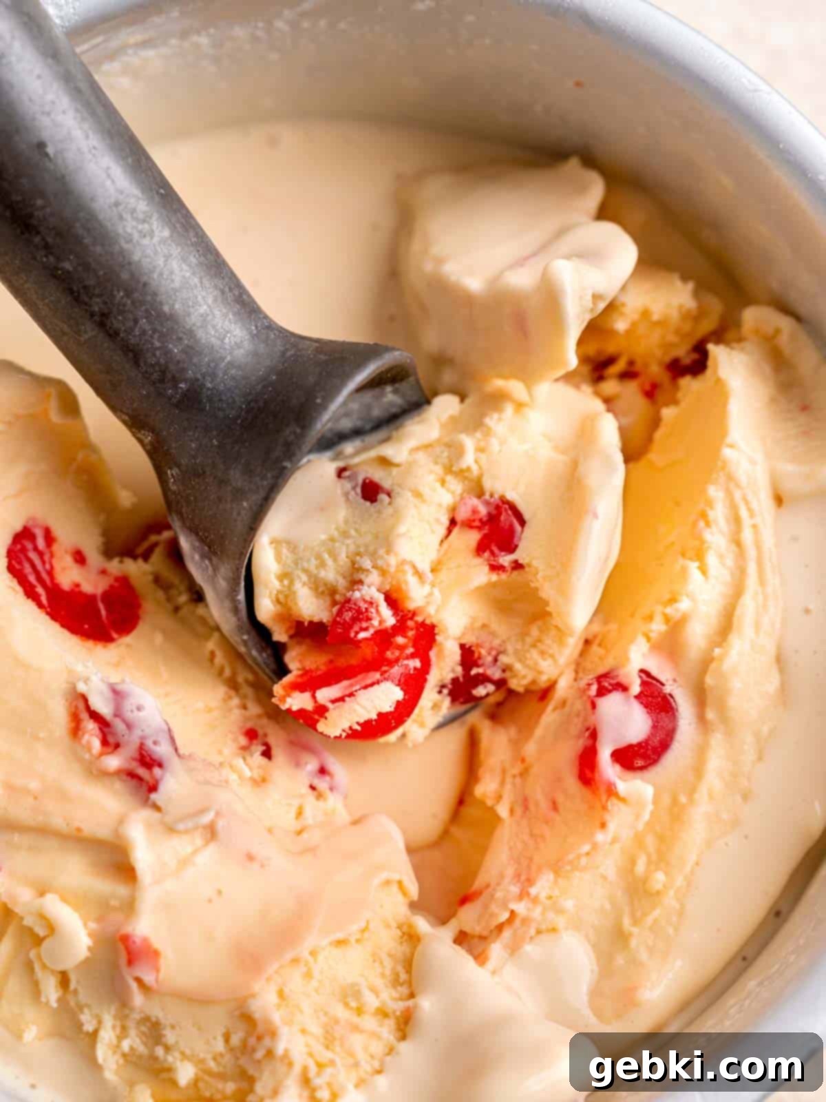 Amaretto Cherry Bliss 10 Scooping cherry amaretto ice cream in a pan.