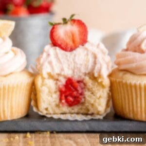 Zesty Lemon Cupcakes with Strawberry Filling 11 A beautifully frosted lemon cupcake with strawberry filling, ready to be enjoyed.