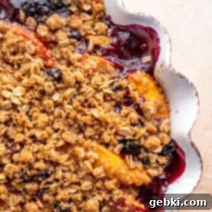 Sweet Summer Blueberry Peach Crisp 10 Blueberry and peach crisp in a pie dish, golden and bubbling from the oven.