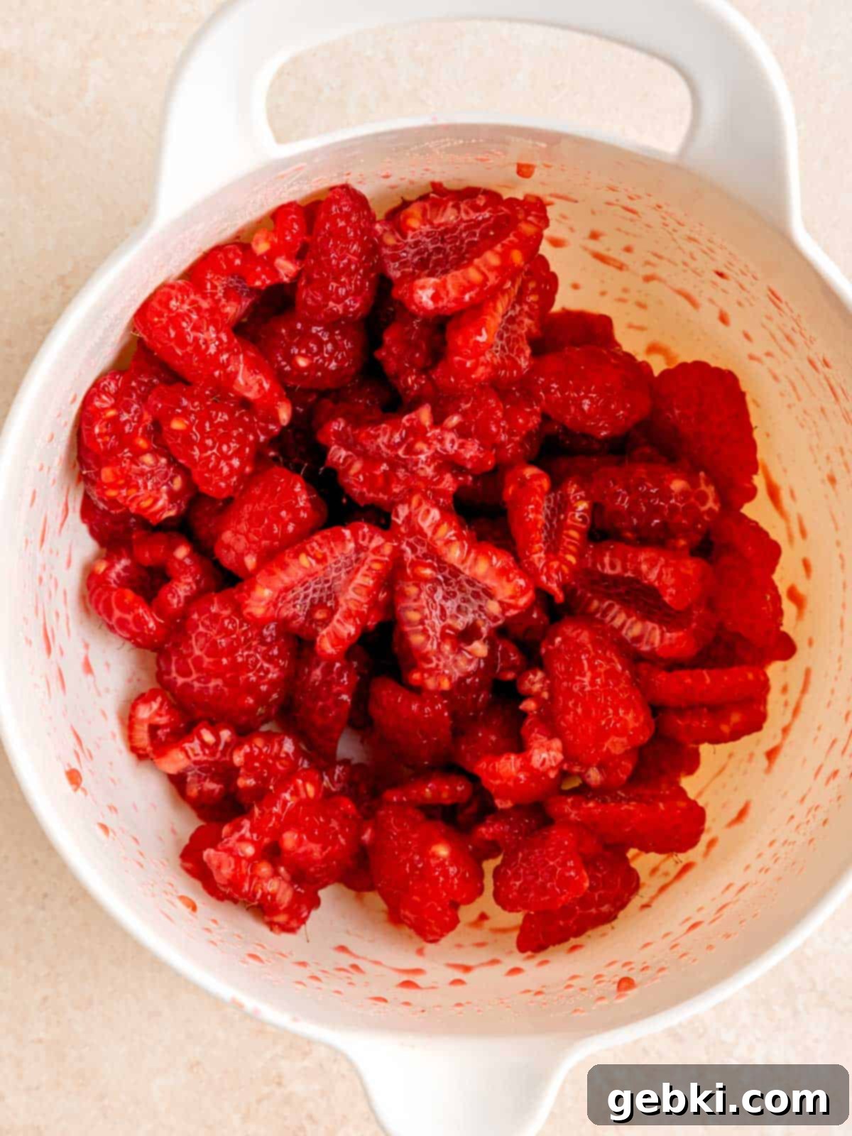 Easy Raspberry Cream Cheese Danish 4 Sliced raspberries mixed with cornstarch, sugar and lemon juice in a bowl.