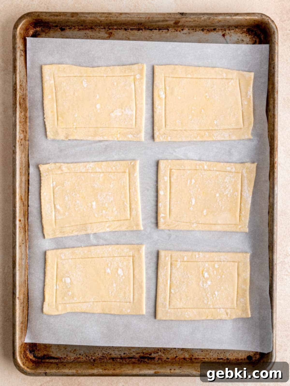 Easy Raspberry Cream Cheese Danish 6 Frozen puff pastry cut into 6 rectangles on a baking sheet.