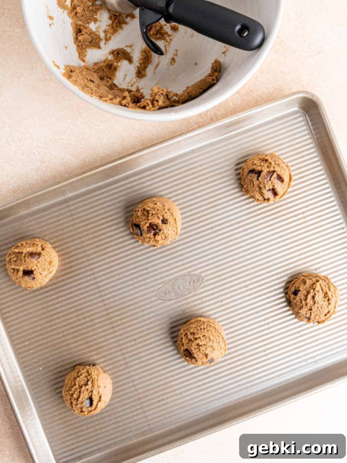 Espresso Sea Salt Chocolate Chip Cookies 7 Chocolate chip espresso cookie dough balls perfectly scooped onto a baking sheet.
