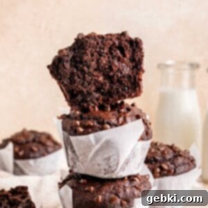 Ultimate Easy Triple Chocolate Brownie Muffins 9 Half of a brownie muffin stacked on whole ones.