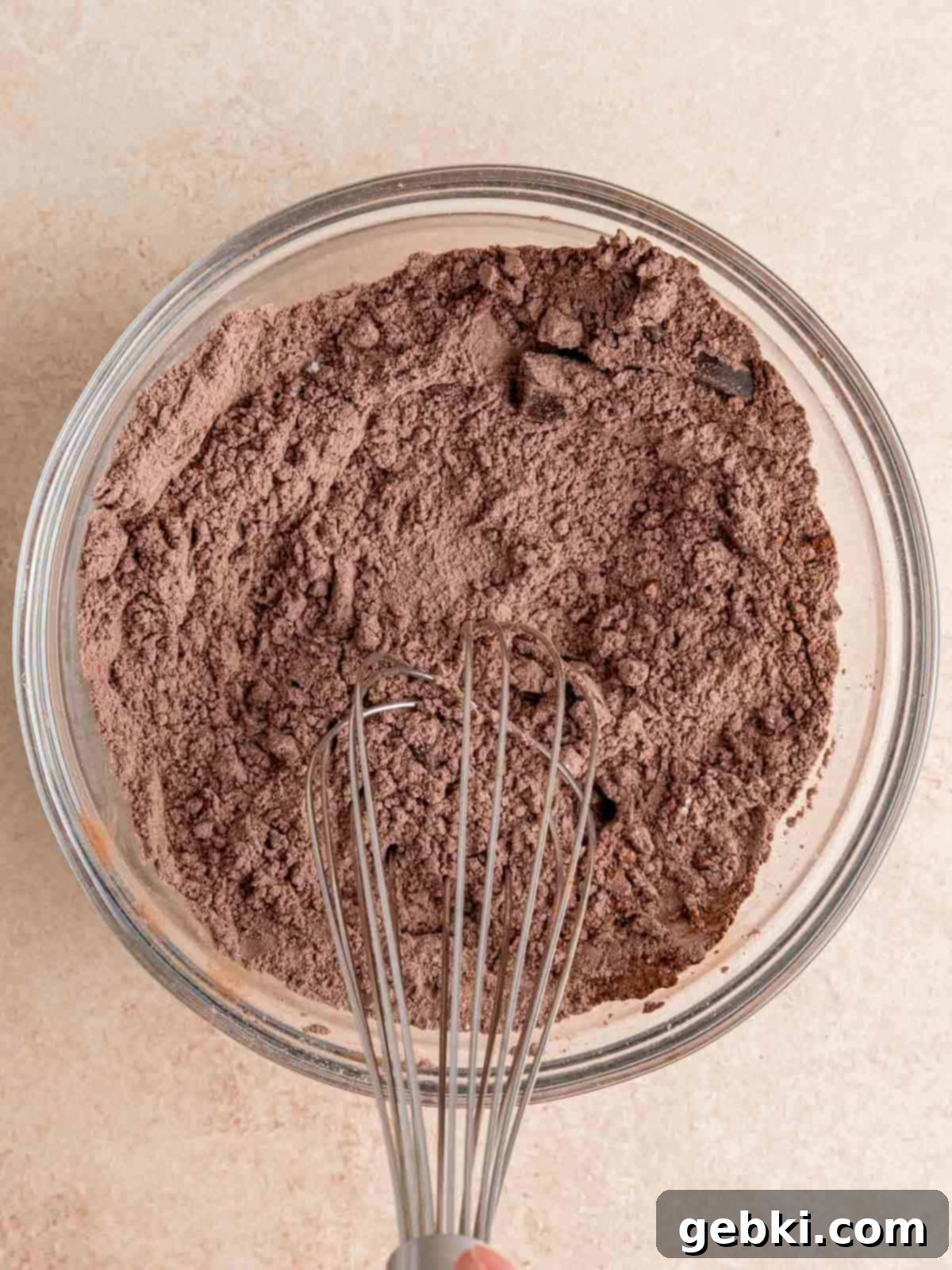 Ultimate Easy Triple Chocolate Brownie Muffins 4 Whisking together flour, baking soda, salt, and cocoa powder in a bowl.