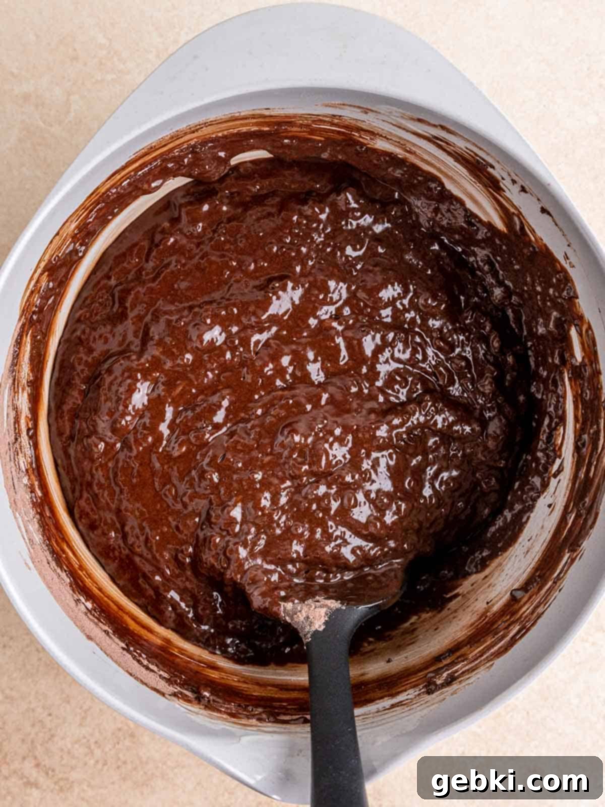 Ultimate Easy Triple Chocolate Brownie Muffins 6 Triple chocolate muffin batter in a bowl with a spatula.