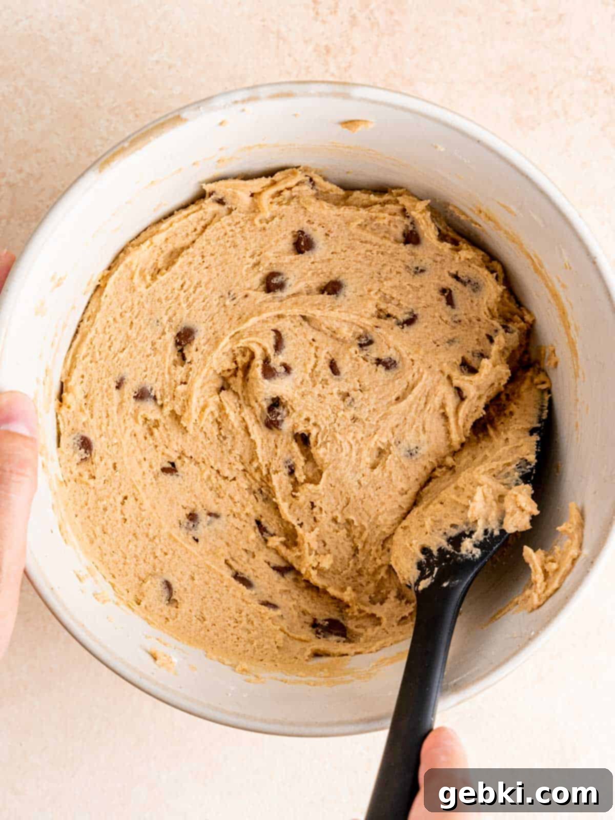 The malted milk chocolate chip cookie dough is fully mixed in a bowl, ready to be scooped onto a baking sheet.