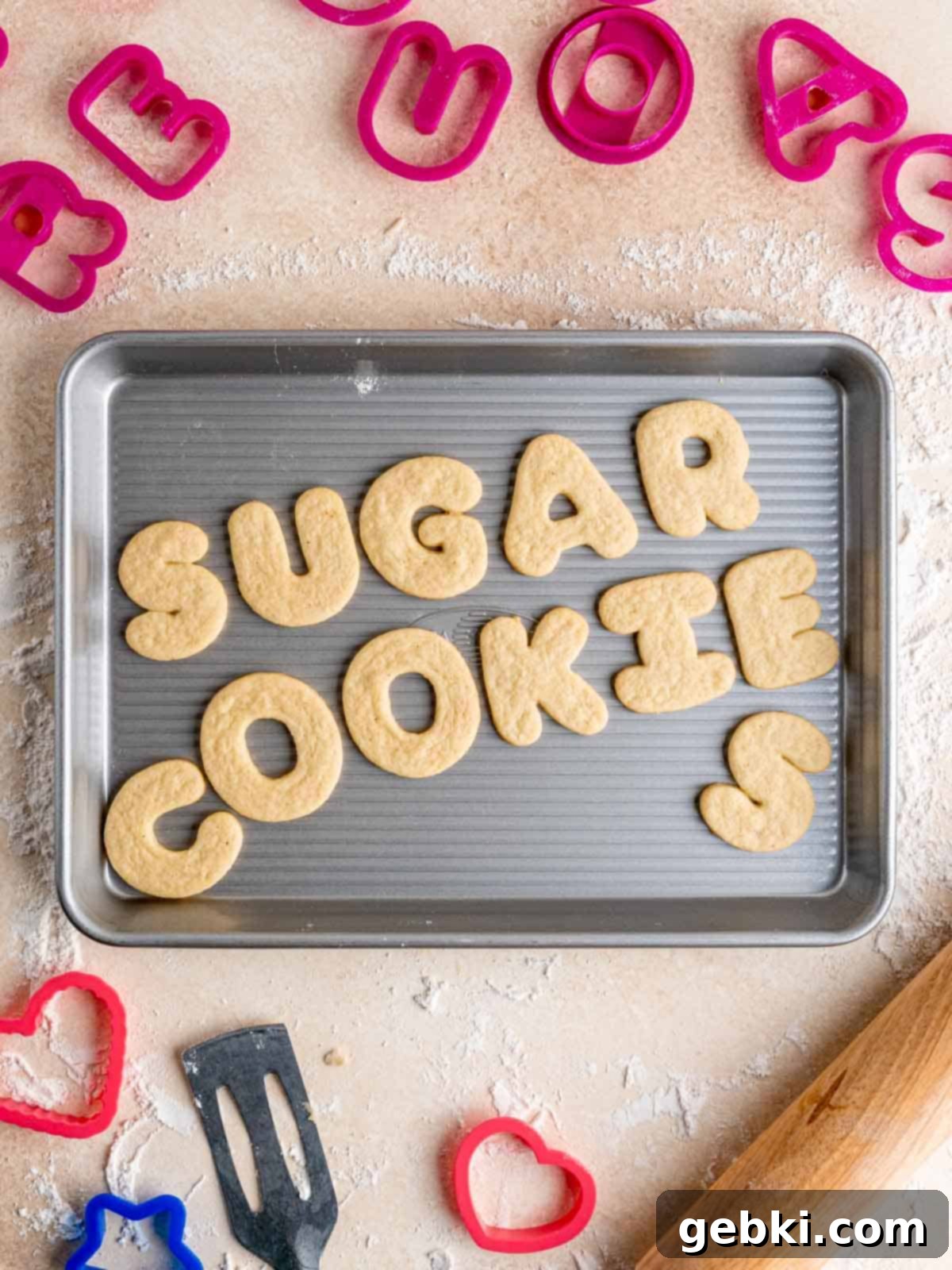 Pillowy Soft Cut-Out Sugar Cookies 2 Soft cut out sugar cookies with lightly browned edges, cooling on a baking sheet, ready for frosting and decoration.