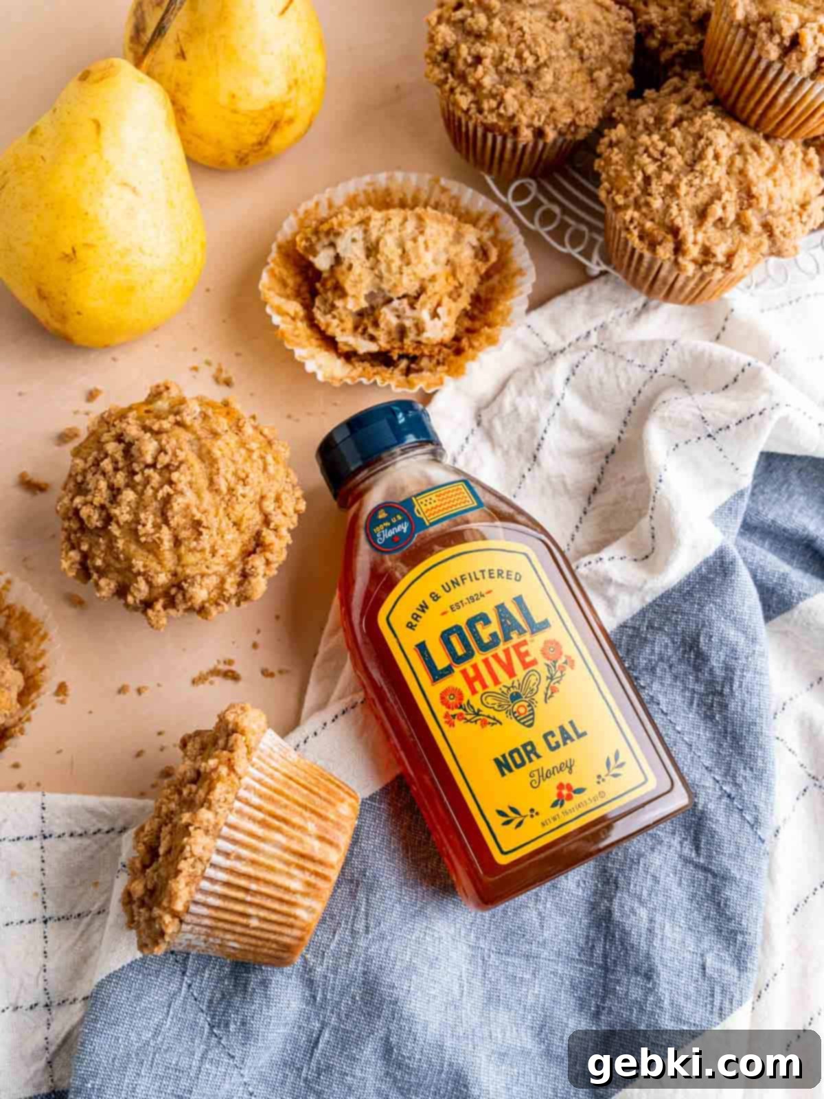 Honey pear muffins with a bottle of Local Hive Honey.