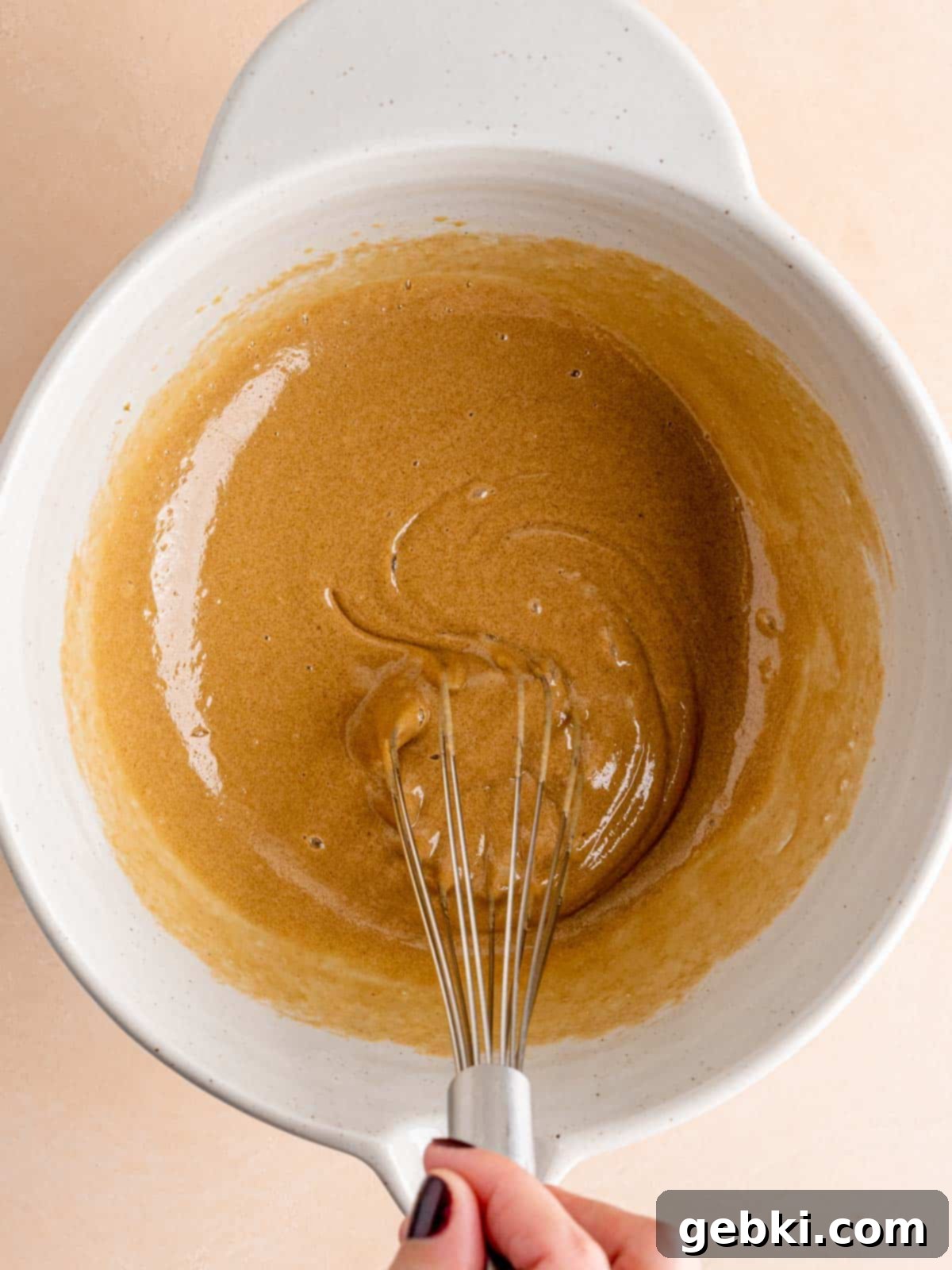 Effortless Fudgy Sourdough Discard Brownies 4 Whisking brown sugar and eggs in a bowl until light and fluffy.