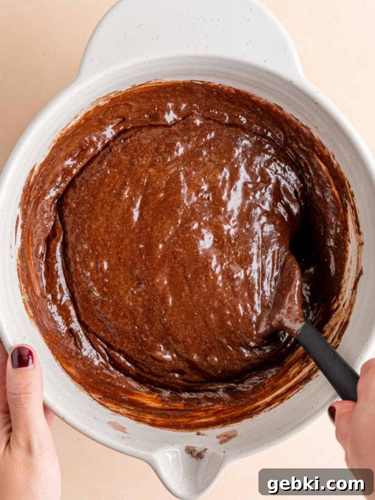 Effortless Fudgy Sourdough Discard Brownies 8 Folding sourdough brownie batter in a bowl with a spatula, just until streaks of flour disappear.