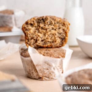 Cinnamon Swirl Banana Bread Muffins 11 A stack of two beautifully baked cinnamon banana bread muffins, showcasing their fluffy texture and crunchy topping.