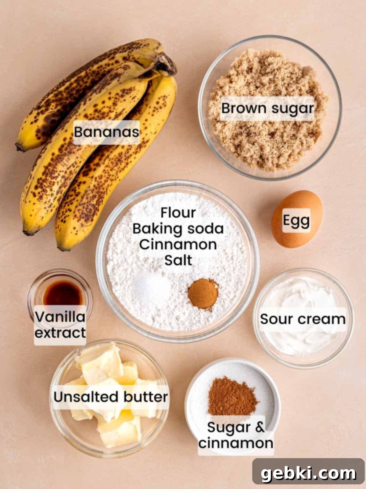 Cinnamon Swirl Banana Bread Muffins 3 A flat lay of ingredients needed to make cinnamon banana bread muffins, including brown sugar, sour cream, and overripe bananas.