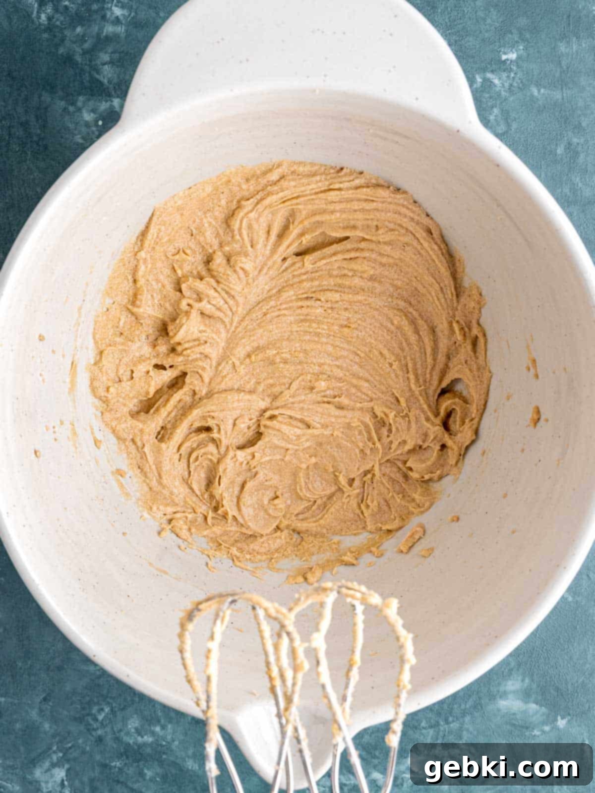 Chewy Sea Salt Butterscotch Oat Cookies 4 Close-up of softened butter, brown sugar, a cracked egg, and vanilla extract being creamed together in a large mixing bowl, showing a light and fluffy texture.