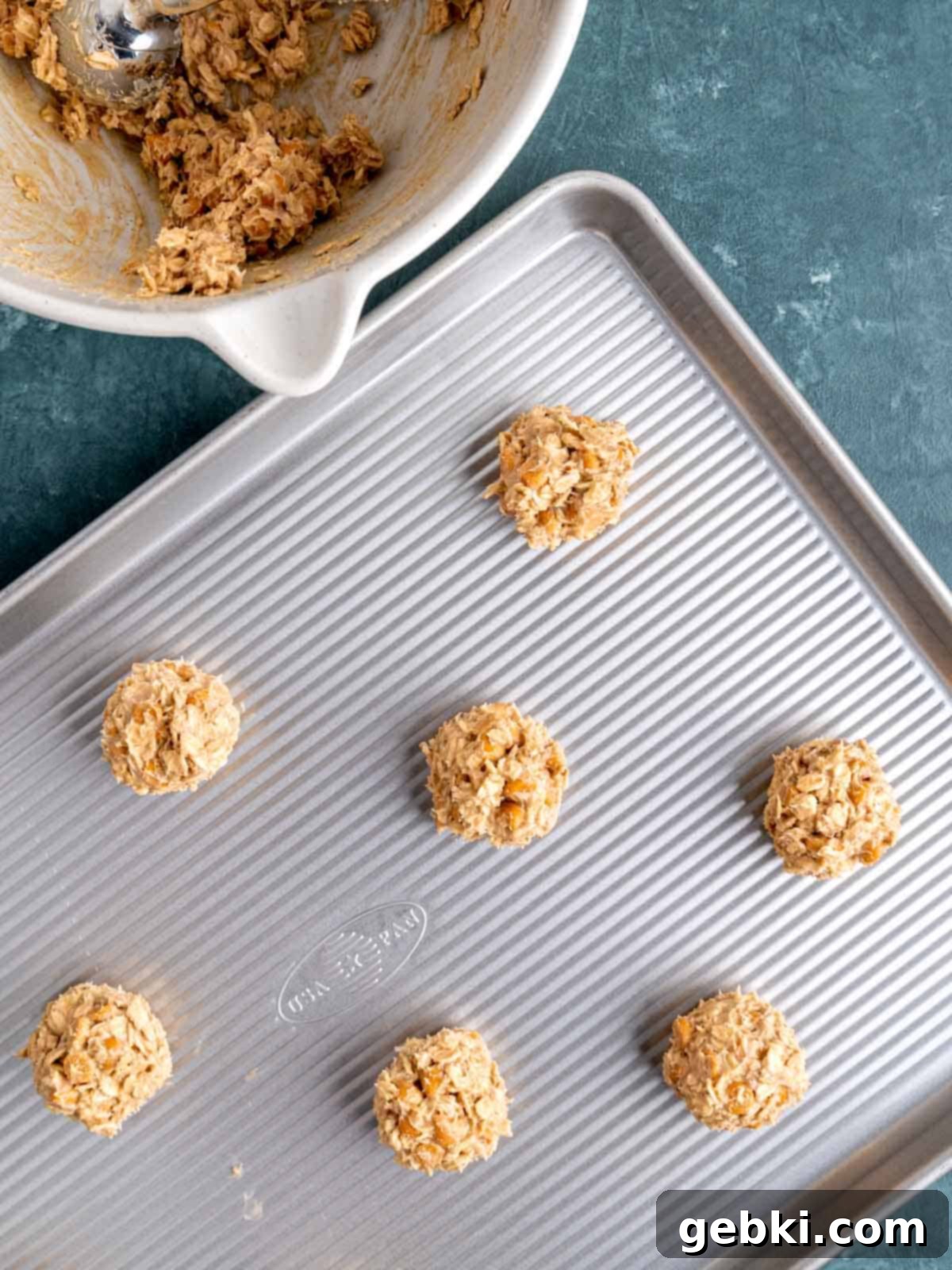 Chewy Sea Salt Butterscotch Oat Cookies 7 Arrangement of perfectly scooped butterscotch oatmeal cookie dough balls on a baking sheet, spaced evenly and ready for baking.