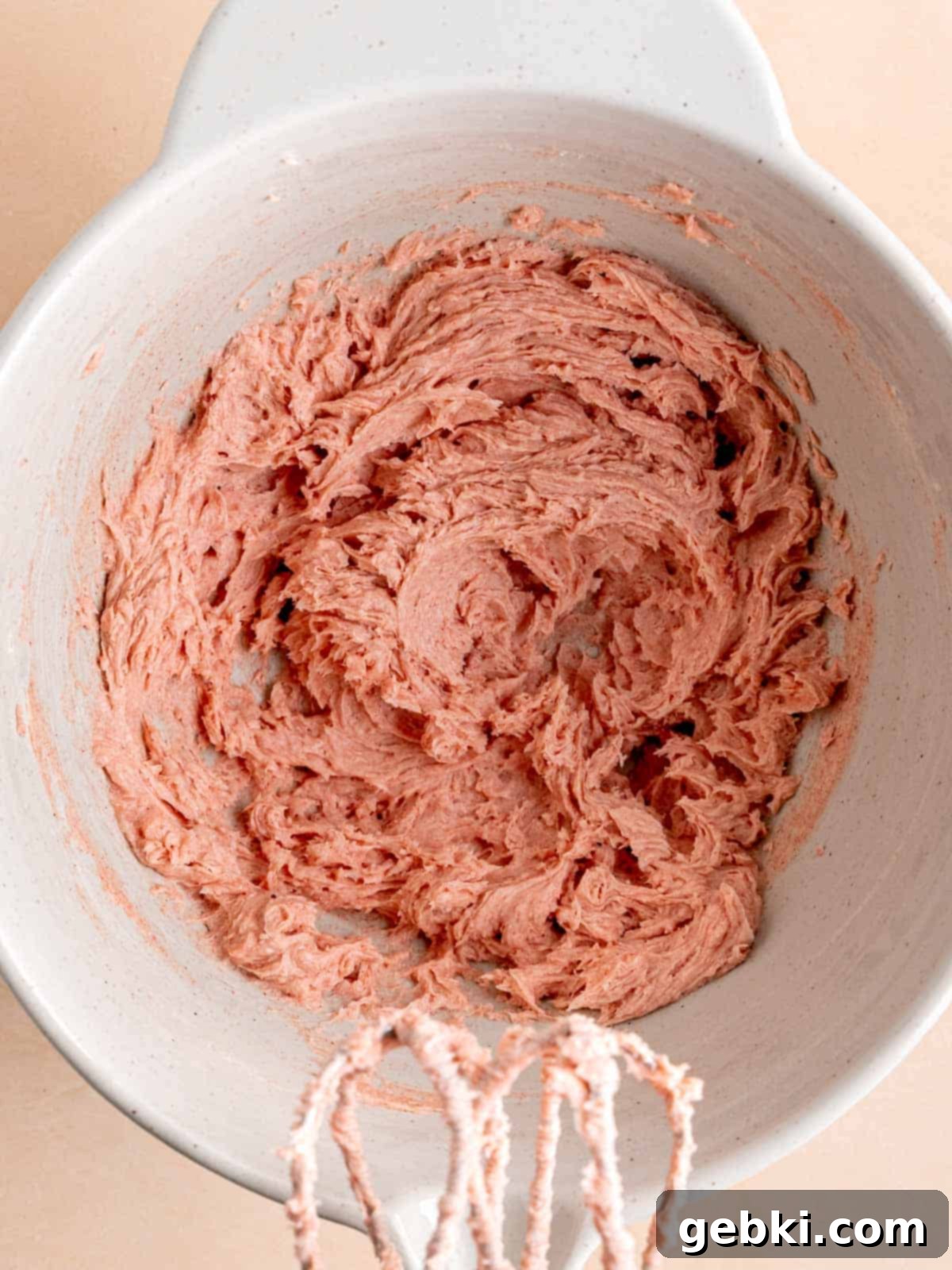 Effortless Strawberry Shortbread Cookies 4 Butter, sugar, powdered sugar, and strawberry powder mixed into a creamy, pink blend in a bowl.