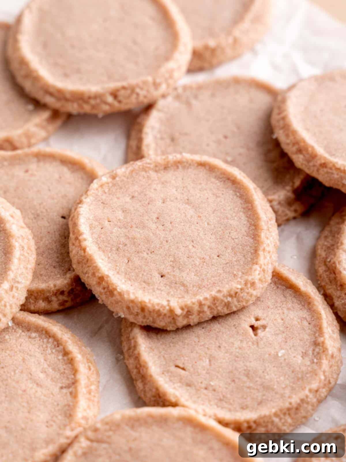 Effortless Strawberry Shortbread Cookies 10 Baked strawberry shortbread cookies, perfectly golden at the edges, on parchment paper.