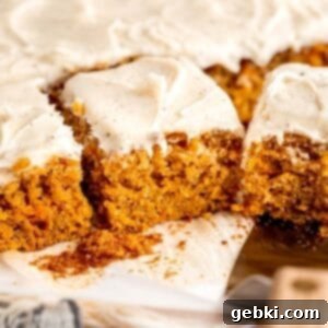 Moist spiced carrot cake with brown butter cream cheese frosting, showing a perfect slice.