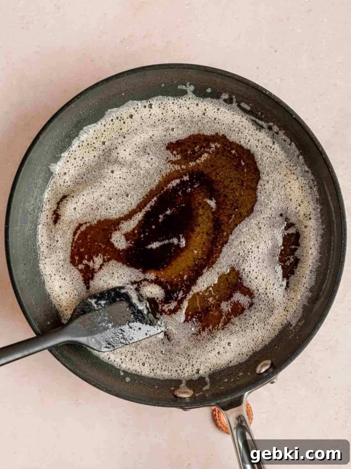 Browning unsalted butter in a skillet until it turns golden brown and smells nutty.