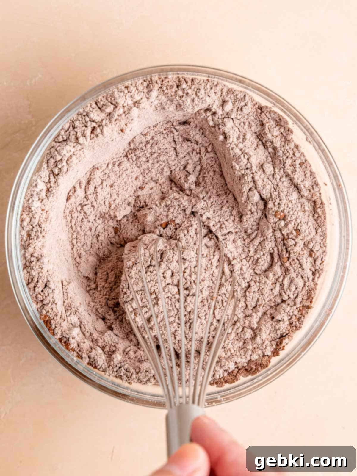 Frosted Red Velvet Donut Indulgence 5 Whisking together flour, cocoa powder, baking powder, and salt.